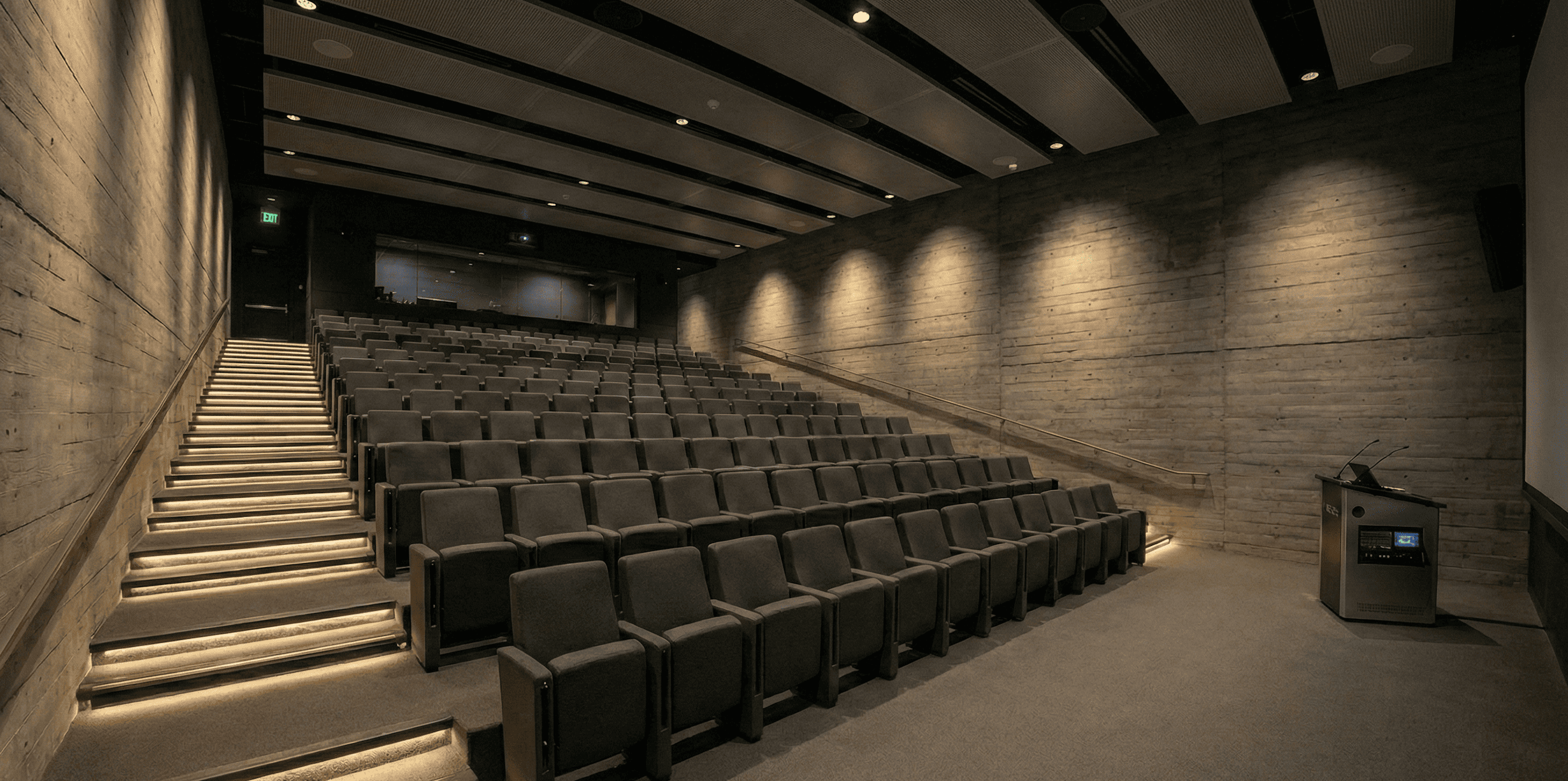 Modern screening room with tiered seating and professional projection setup